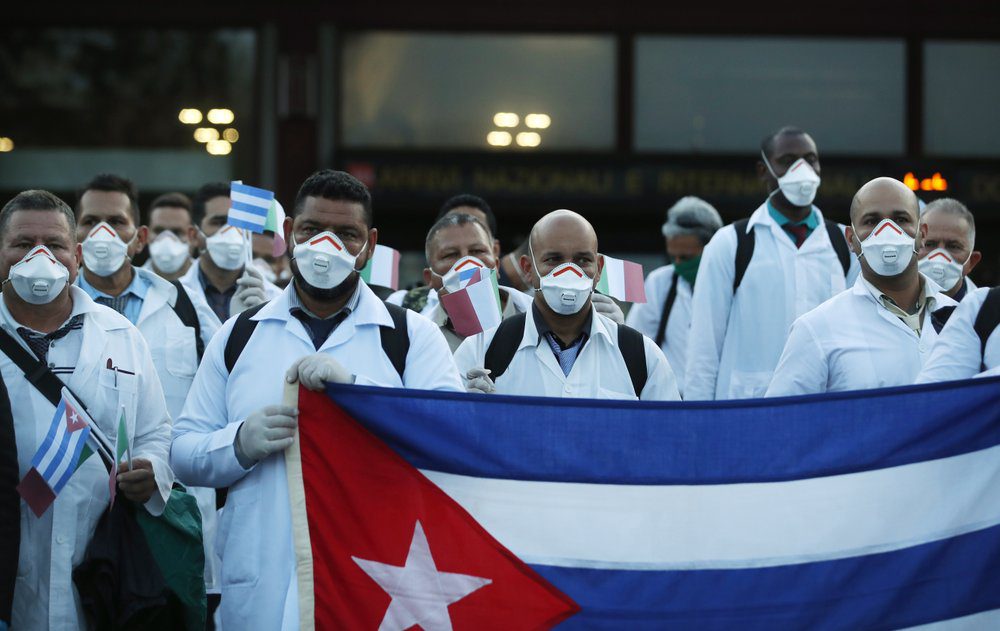 masked Cuban Doctors protest with Cuban flag