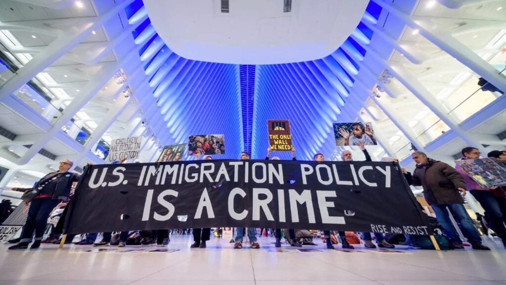 Banner that says US Immigration Policy is a crime