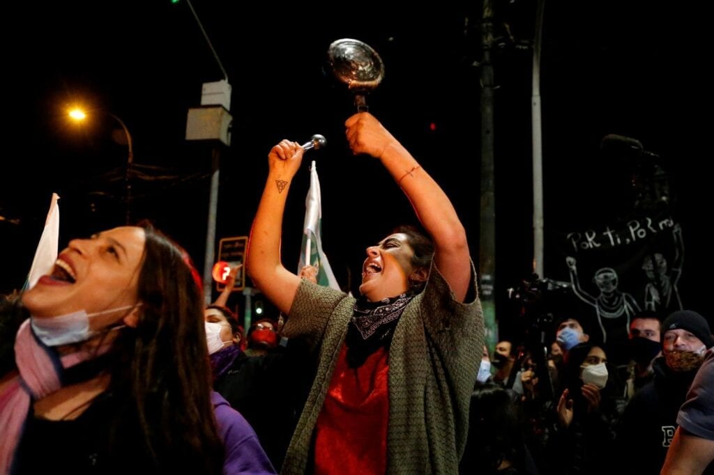 A woman bangs a pot as she reacts to the referendum on a new Chilean constitution in Valparaiso, Chile, October 25, 2020. REUTERS/Rodrigo Garrido