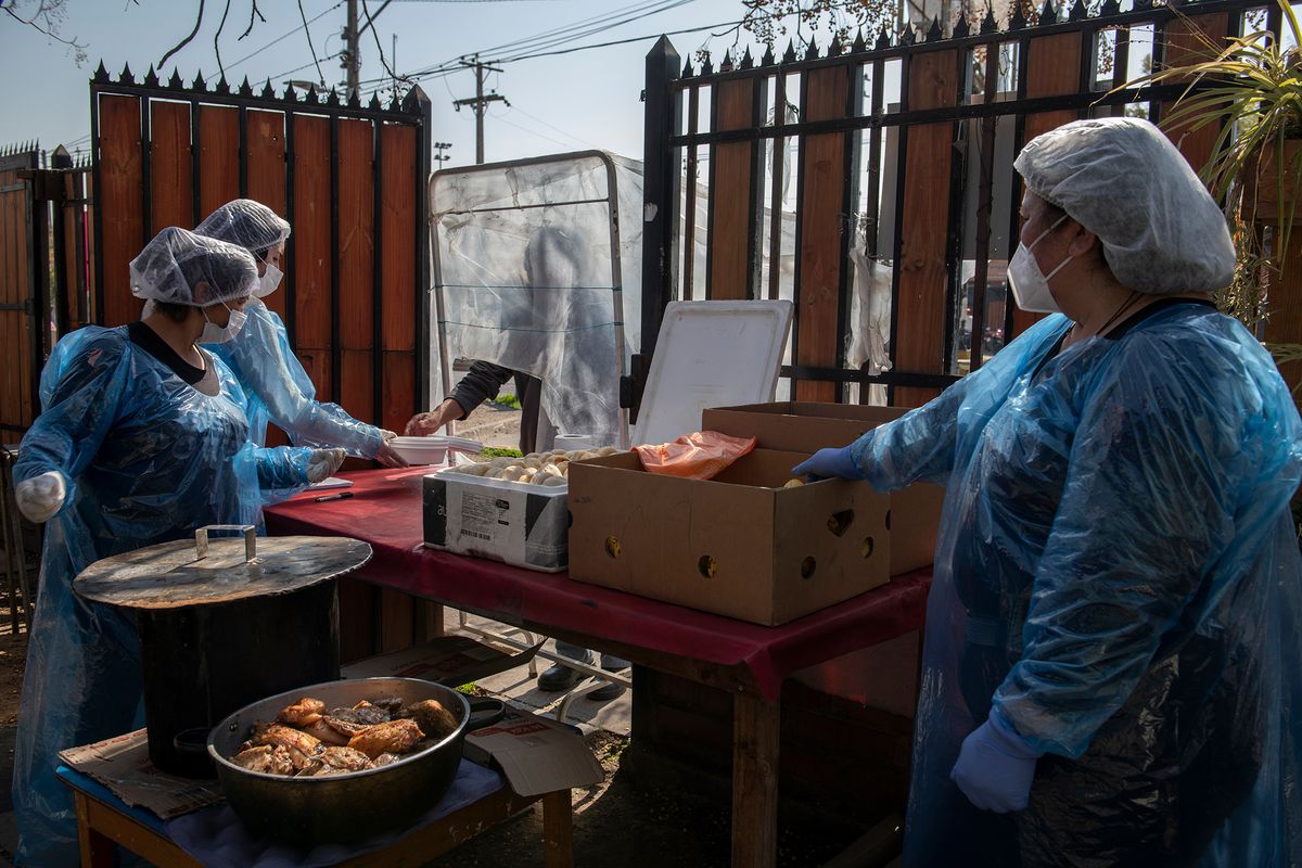 Workers preparing food in PPE