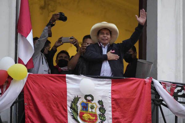 Pedro Castillo waving from balcony