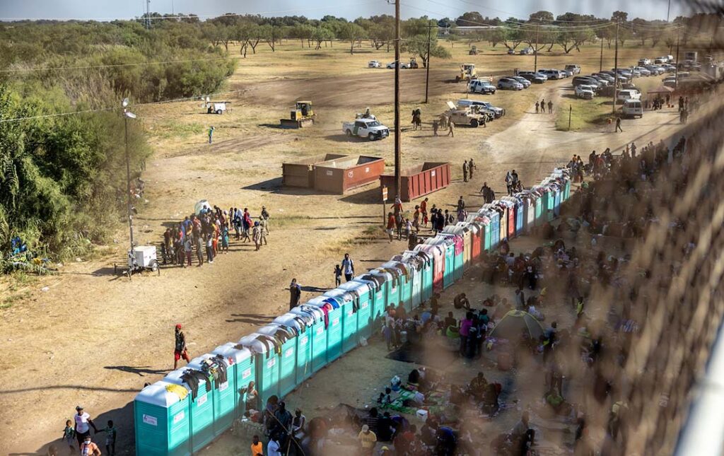 Migrants, mostly from Haiti, gather at a makeshift encampment under the International Bridge on the border between Del Rio, TX and Acuña, MX